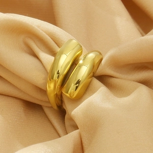 Minimalist golden wrap ring elegantly displayed on luxurious champagne silk fabric