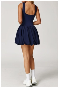 Back view of a navy blue backless sports dress with puff hem for running and tennis