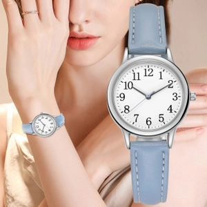 Close-up of light blue leather watch strap with white stitching and silver round case