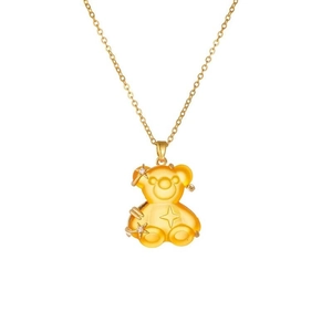 Detail of a resin teddy bear pendant with gold plating and star-shaped zircon accents