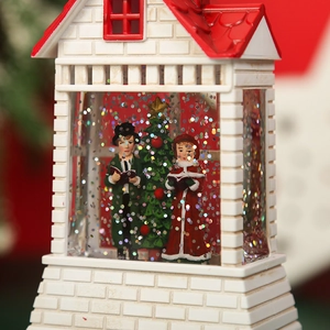 Close-up of red and white Christmas house lantern with festive figures and glitter liquid