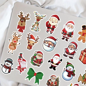 Close-up of colorful Christmas cartoon stickers applied on a silver laptop back