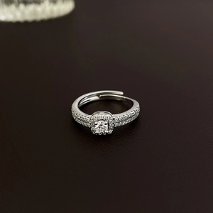 Macro shot of silver open ring with square halo setting and elegant sparkling crystals