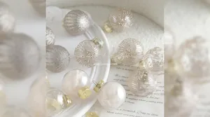Champagne and white Christmas ornaments set with glitter and feather filling
