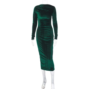 Detail of emerald green velvet fabric texture and ruched design on slim fit midi dress