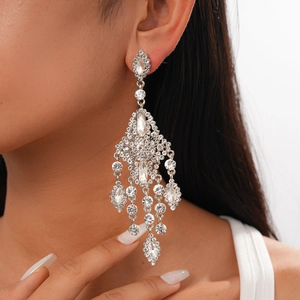 Close-up of luxury long tassel chandelier earrings with sparkling crystal rhinestones