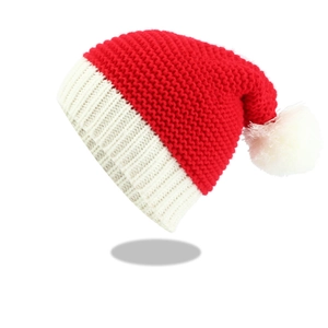 Detailed view of the classic red and white Christmas knit hat with fuzzy white pom-pom