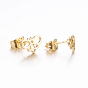Macro detail of gold-toned hollow bee stud earrings with mirror reflection on white base