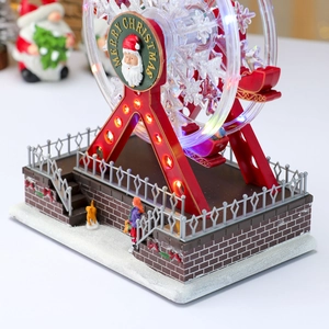 Close-up of a rotating Christmas Ferris wheel with LED lights and festive micro-landscapes