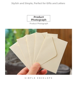 Detail of cream mini kraft paper envelope with V-flap closure held in hand for gift cards