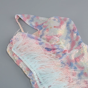 Close-up of sparkling colorful sequins and ostrich feather trim on a party dress
