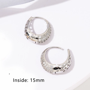 Macro detail of 15mm pave hoop earrings with hollow heart side patterns and zircon stones