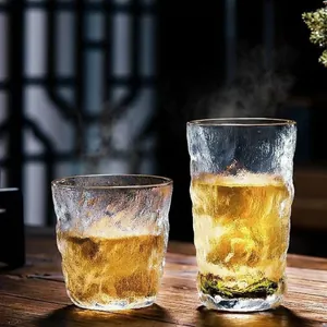 Japanese glacier textured glass cup set in tall and short sizes on dark wooden surface