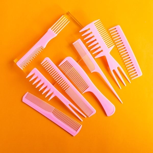 8-piece pink plastic hair comb set including wide tooth and tail combs on orange background