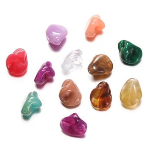 Close-up of colorful irregular acrylic beads with marble texture for DIY jewelry making