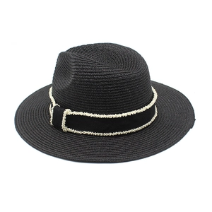 Detailed view of black woven straw fedora hat featuring white beaded decorative band trim