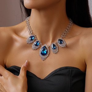 Detail shot of vintage silver chain necklace with blue pear-cut crystal pendants