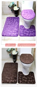 Close-up of pebble textured memory foam bathroom mat set in purple and brown