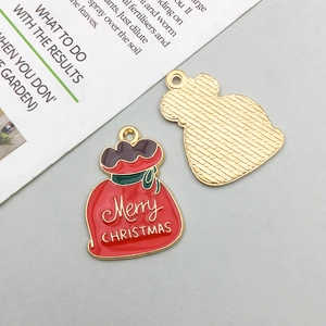 Macro detail of Christmas gift bag enamel pendant showing front and gold textured back