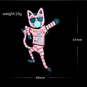Detail showing pink dabbing cat enamel pin with dimensions 63mm by 40mm and 10g weight