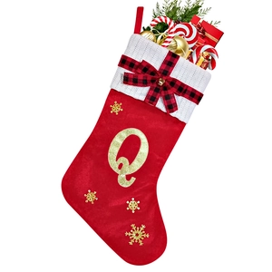 Detail of red Christmas stocking with knitted cuff and sparkling gold letter Q design