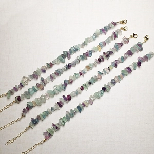 Detail of natural fluorite crystal gravel bracelets with purple and green stones