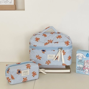 Detailed set of blue striped quilted makeup bags with cute bear patterns and bow zippers