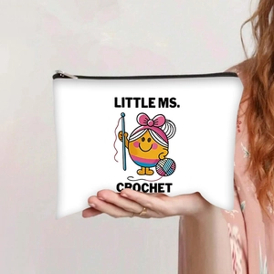 Detail of white canvas crochet pouch featuring yellow cartoon character and zipper closure