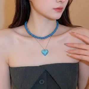 Double-layered necklace with blue beads and heart pendant for a trendy feminine look