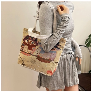 Ethnic owl canvas tote bag shown on shoulder for daily use with spacious woven texture