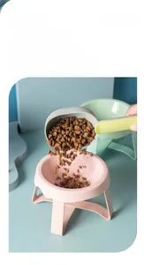 Detail of pink and green elevated ceramic pet bowls with a scoop for neck protection