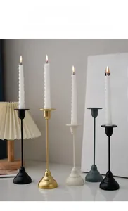 Minimalist metal candle holder set with slender stands and conical bases for table decor