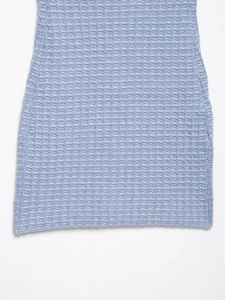 Detailed close-up of light blue waffle knit fabric texture on a slim-fit dress