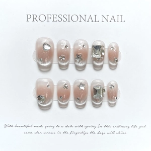 Pink cat eye press-on nails with silver glitter gradient and 3D rhinestones