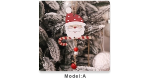Detail of wooden Santa Claus ornament with candy cane and red bell on a snowy tree