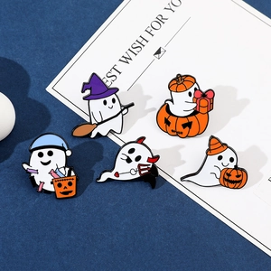 Macro view of five Halloween ghost enamel pins with pumpkin and candy basket details