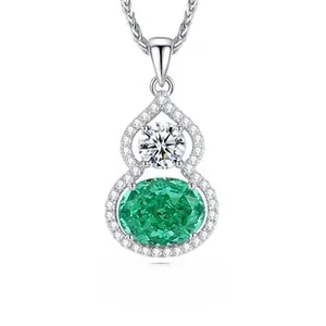 Macro view of S925 silver gourd pendant with oval emerald and sparkling white gemstones