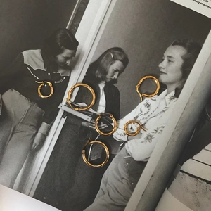 Detailed view of three pairs of golden stainless steel hoop earrings in mixed sizes