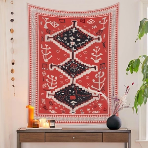 Bohemian ethnic tribal tapestry with red and black totem pattern hanging in a home setting