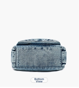 Close-up of rectangular denim bag base with reinforced stitching and washed blue texture