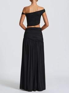 Rear view of black two-piece set featuring off-shoulder crop top and pleated maxi skirt