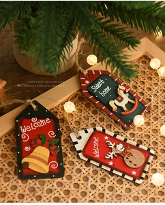 Detail of wooden Christmas ornaments with reindeer and rocking horse on warm festive background