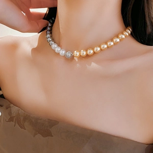 Detail of vintage French pearl necklace with gold beads and sparkling crystal clasp