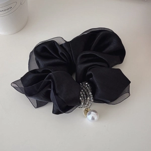 Detail of black satin scrunchie with organza edge, crystal beads and white pearl pendant