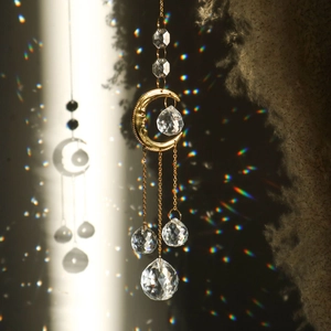 Golden suncatcher with moon relief and multi-faceted crystals casting rainbow spots