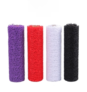 Detailed close-up of decorative hollow floral mesh rolls in purple, red, white, and black