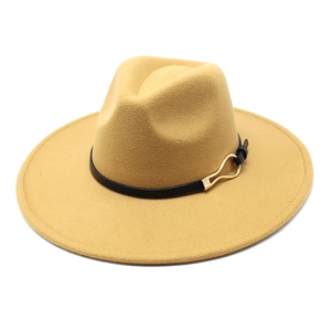 Detail of wide brim fedora hat showing golden metal buckle on black leather strap