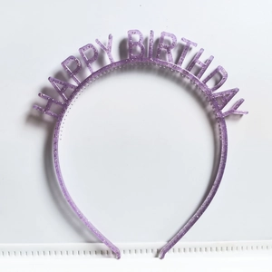 Close-up of purple glitter plastic headband featuring Happy Birthday lettering
