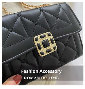 Detailed close-up of a quilted black leather bag with a vintage gold jeweled buckle