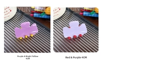 Macro shot of 4cm candy-colored acrylic hair claw clips in purple and yellow dual tones